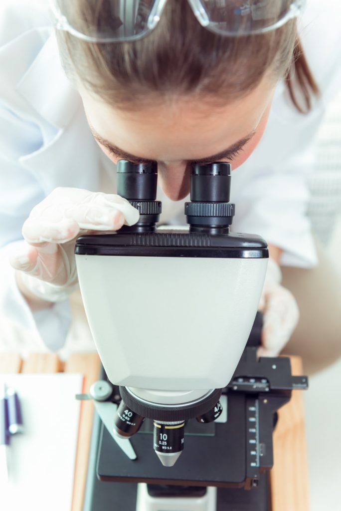 scientist-using-microscope-laboratory
